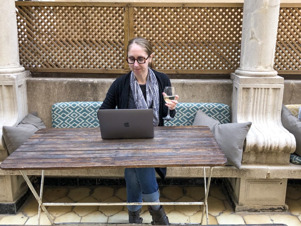 Alyssa works with a glass of wine to find the best way to avoid coronavirus travel delays during spring break.