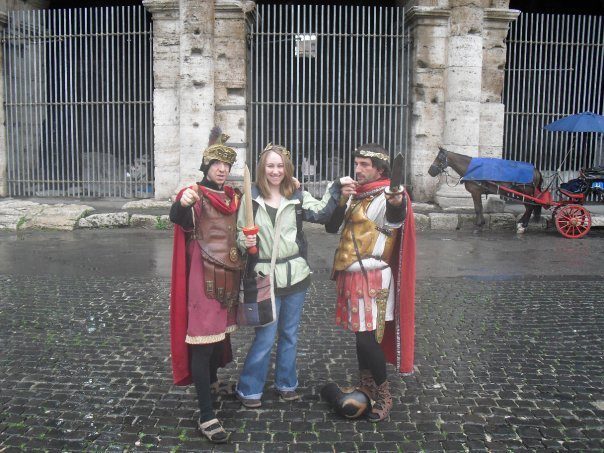 Alyssa standing with men dressed as Gladiators