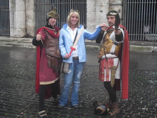 Alyssa's sister standing with men dressed as Gladiators