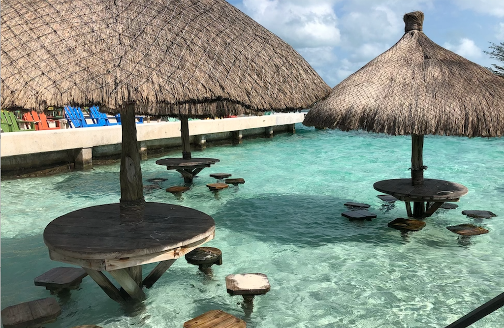 Covered tables in Belize, a surprisingly affordable destination.