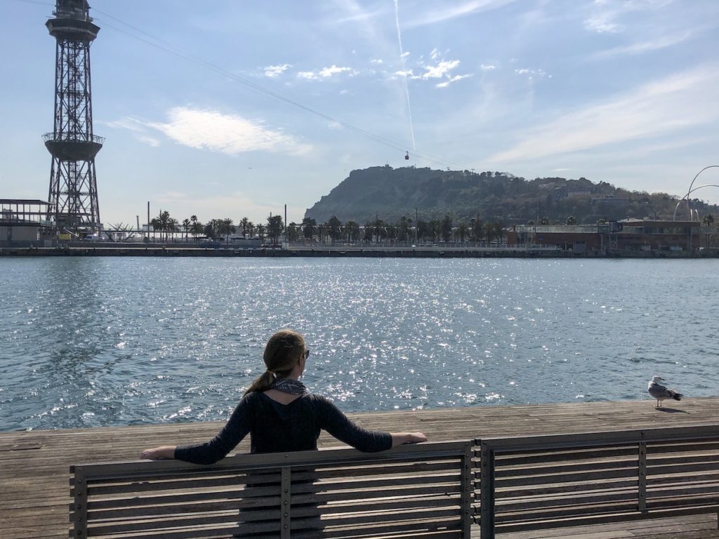 Alyssa sits on a bench overlooking the water over spring break.